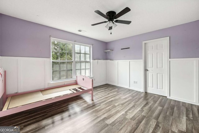 unfurnished bedroom featuring hardwood / wood-style floors and ceiling fan