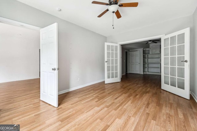 empty room featuring ceiling fan, light hardwood / wood-style flooring, and french doors