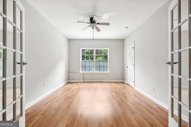 empty room featuring french doors, light hardwood / wood-style flooring, and ceiling fan