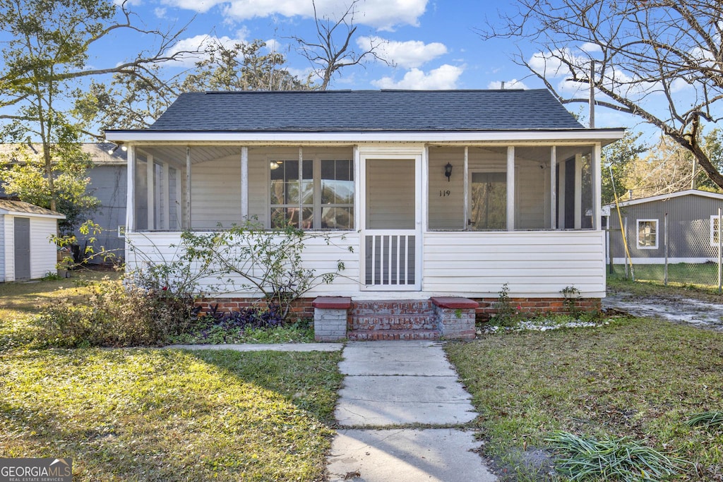 bungalow-style home with a front lawn