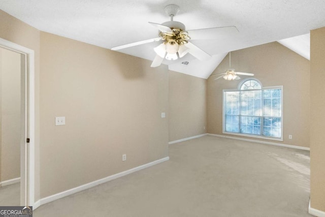 carpeted empty room with ceiling fan and lofted ceiling