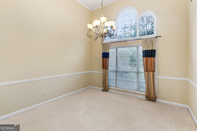 carpeted empty room featuring a notable chandelier