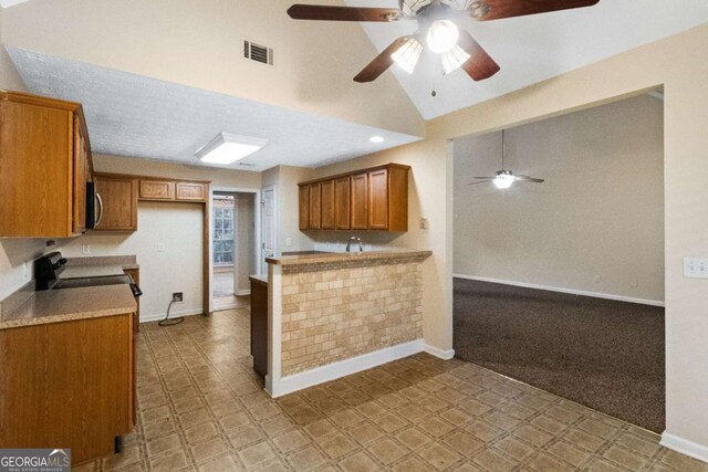 kitchen featuring stove, high vaulted ceiling, ceiling fan, light colored carpet, and kitchen peninsula