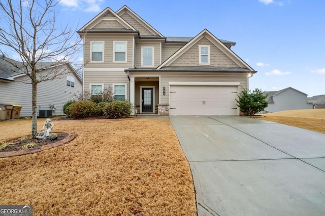 craftsman-style house featuring central AC unit and a garage