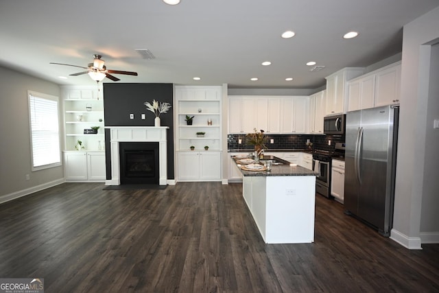 kitchen featuring sink, stainless steel appliances, dark hardwood / wood-style flooring, an island with sink, and white cabinets