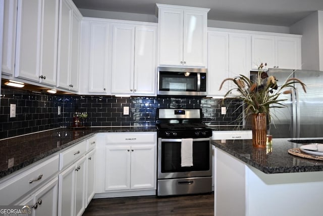 kitchen with white cabinets, stainless steel appliances, and tasteful backsplash