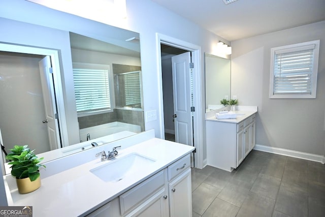 bathroom featuring vanity and independent shower and bath