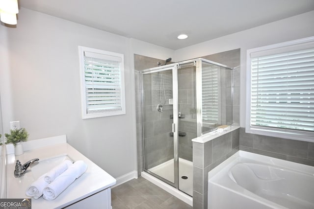 bathroom with tile patterned floors, vanity, and plus walk in shower