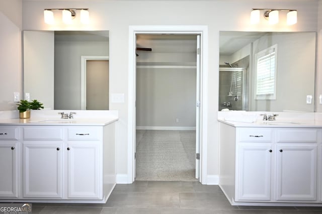 bathroom featuring tile patterned floors, vanity, and walk in shower