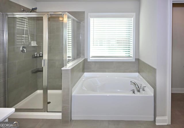 bathroom with tile patterned flooring, vanity, a healthy amount of sunlight, and separate shower and tub