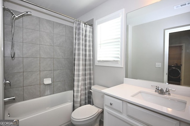 full bathroom featuring vanity, toilet, washer / clothes dryer, and shower / tub combo with curtain