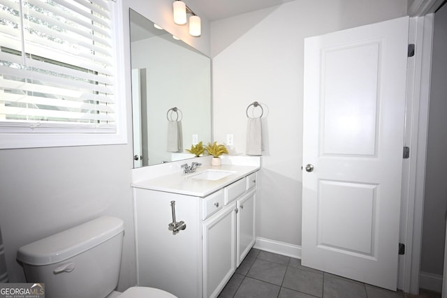 bathroom with tile patterned flooring, vanity, and toilet