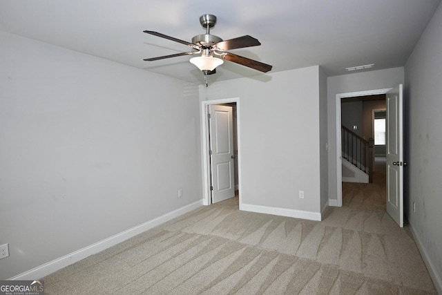 carpeted empty room featuring ceiling fan