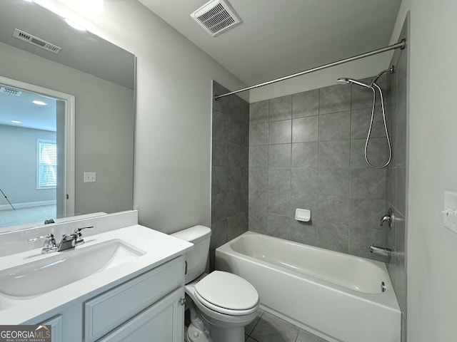 full bathroom with tile patterned floors, tiled shower / bath combo, toilet, and vanity