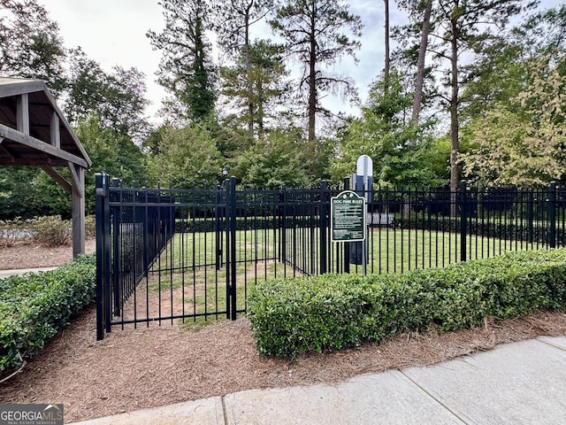 view of gate with a yard