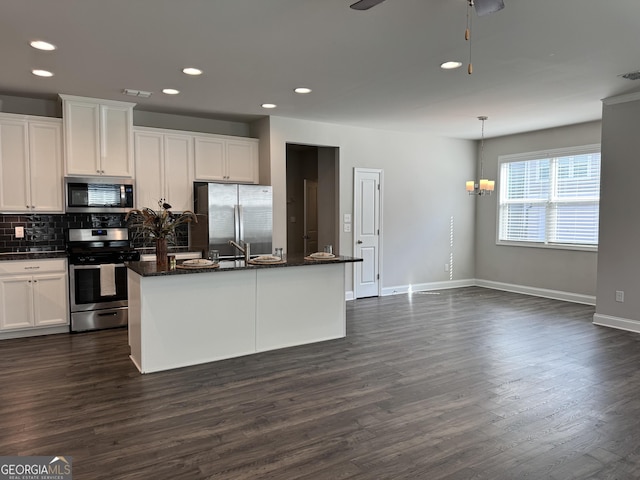 kitchen featuring appliances with stainless steel finishes, white cabinetry, and an island with sink