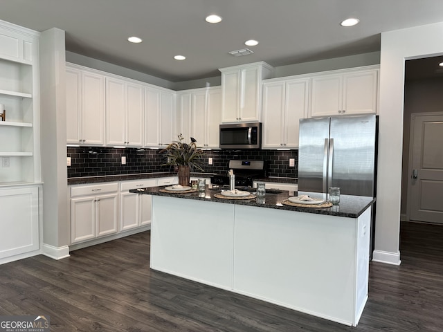 kitchen with a kitchen island, white cabinetry, and stainless steel appliances