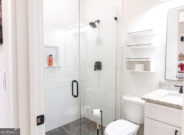 bathroom featuring tile patterned floors, vanity, toilet, and walk in shower