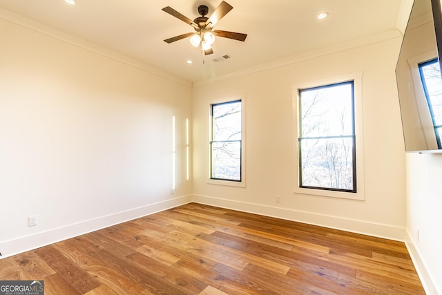 spare room with ceiling fan, light hardwood / wood-style flooring, and ornamental molding