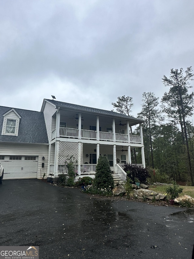 view of front of property featuring covered porch and a garage