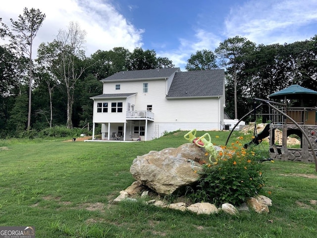 back of house featuring a patio area, a playground, and a lawn