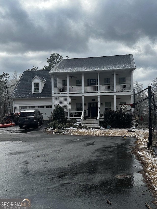 view of front of home with covered porch, a balcony, and a garage