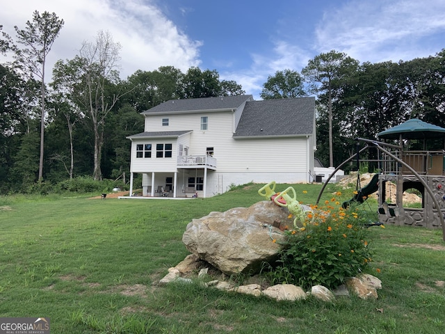 back of house with a patio area, a playground, and a lawn