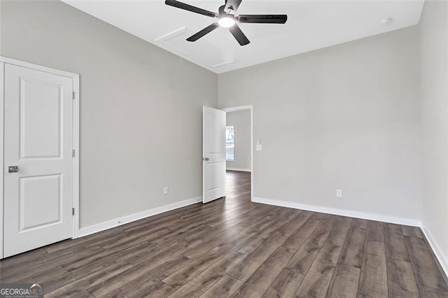 empty room with ceiling fan and dark wood-type flooring