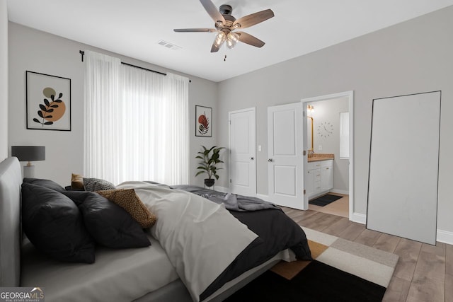 bedroom with ceiling fan and connected bathroom