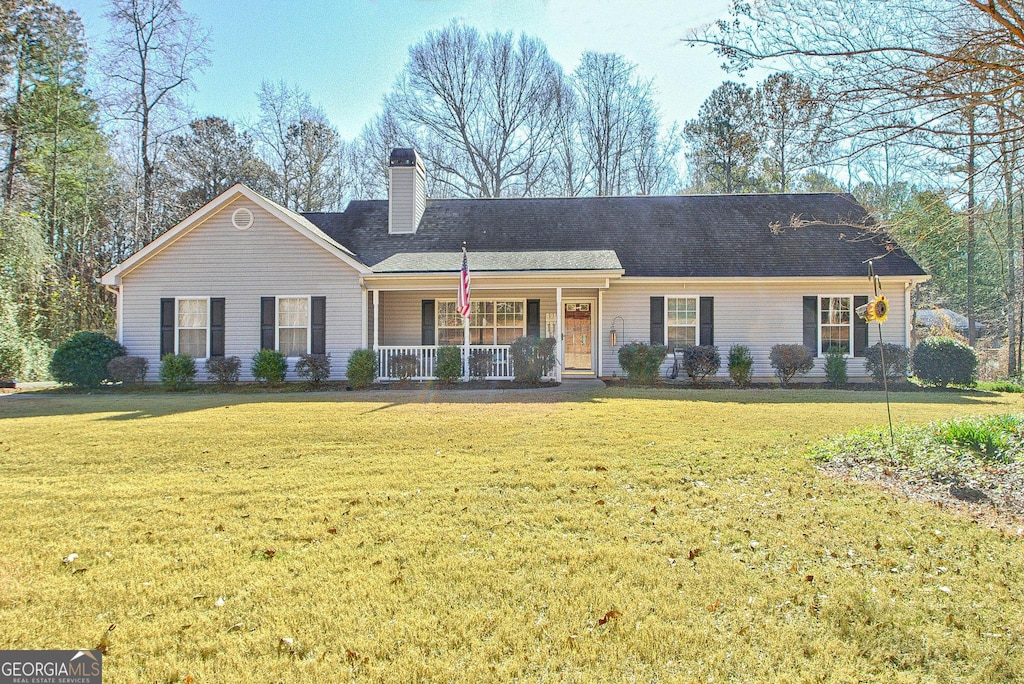 single story home with a porch and a front yard