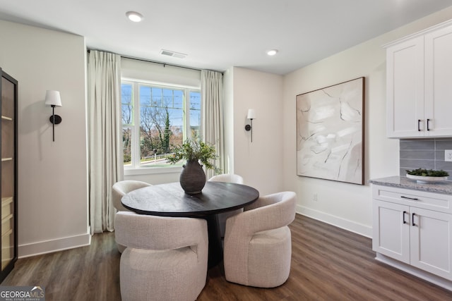 dining room with dark hardwood / wood-style flooring