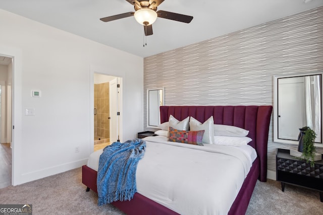 bedroom featuring ceiling fan, light carpet, and connected bathroom