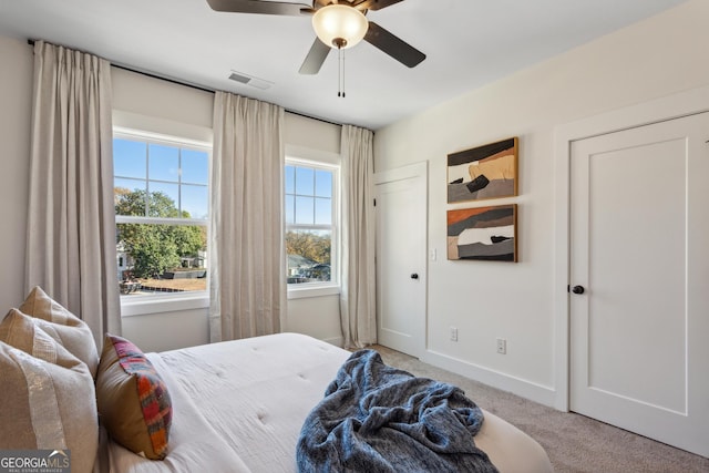 bedroom featuring ceiling fan and light carpet