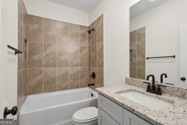 full bathroom featuring vanity, toilet, and tiled shower / bath combo