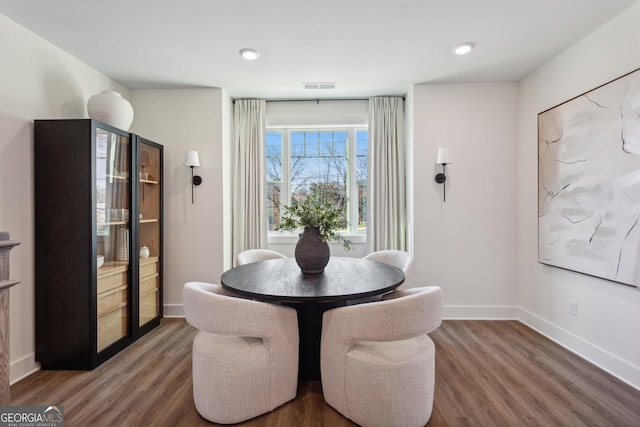 dining space featuring dark wood-type flooring