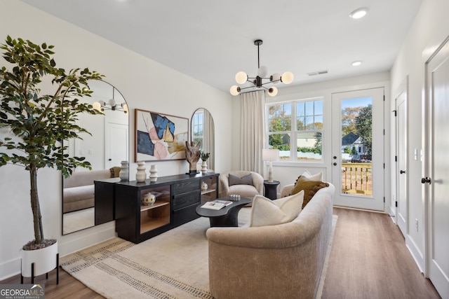 living room featuring a chandelier and hardwood / wood-style flooring