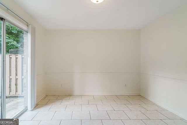 unfurnished room with light tile patterned flooring