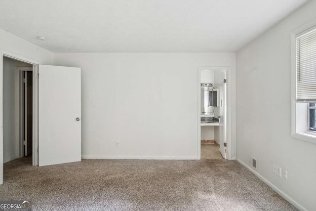 carpeted spare room featuring a wealth of natural light