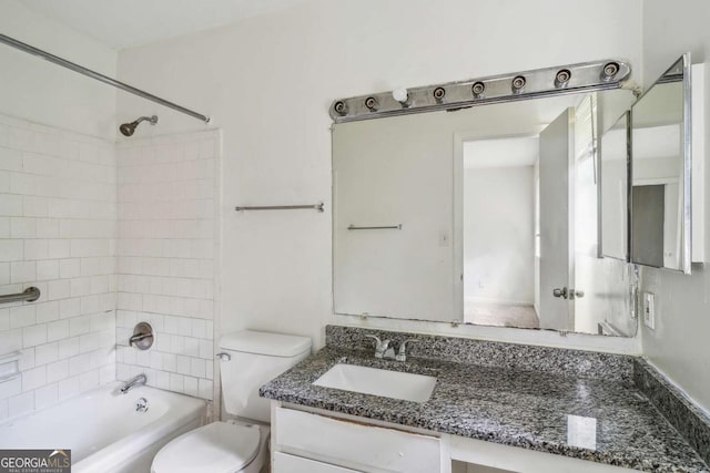 full bathroom featuring vanity, toilet, and tiled shower / bath