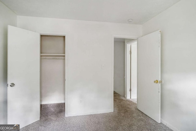 unfurnished bedroom featuring a closet and carpet floors