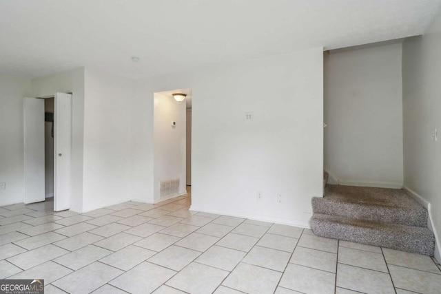 spare room featuring light tile patterned floors