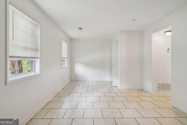 empty room with light tile patterned floors