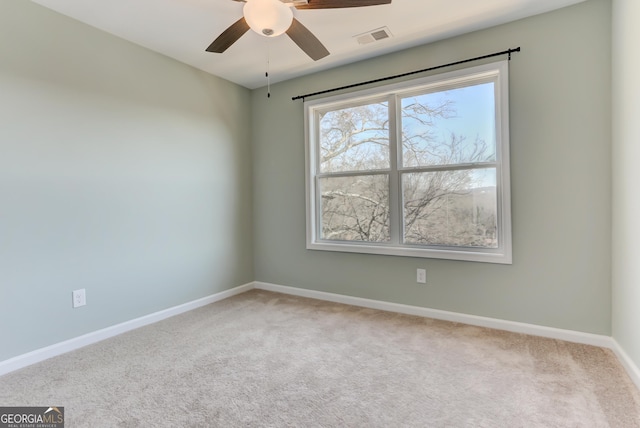 carpeted spare room with ceiling fan