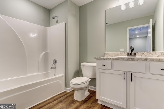 full bathroom featuring vanity, hardwood / wood-style flooring, shower / bathing tub combination, and toilet