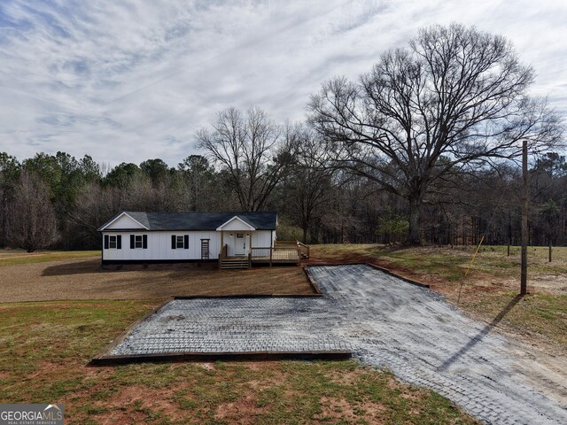 view of front of home featuring a wooden deck