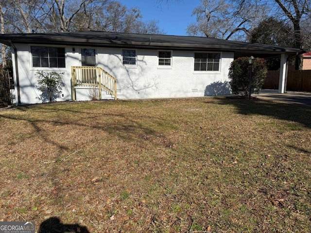 rear view of property featuring a yard