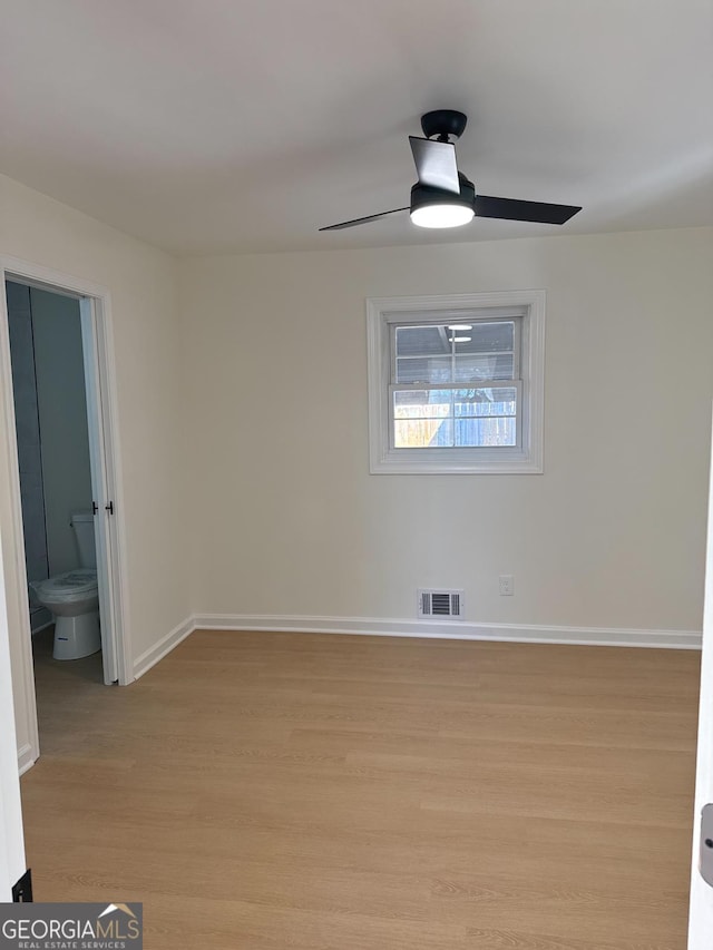 empty room with ceiling fan and light wood-type flooring