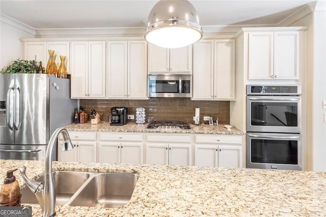 kitchen featuring tasteful backsplash, crown molding, sink, and appliances with stainless steel finishes