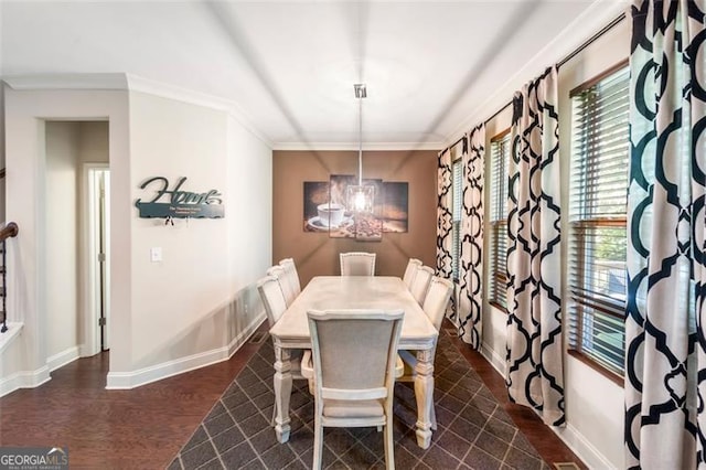 dining room featuring ornamental molding, dark hardwood / wood-style flooring, and a notable chandelier