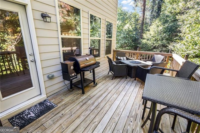 deck featuring a fire pit and area for grilling